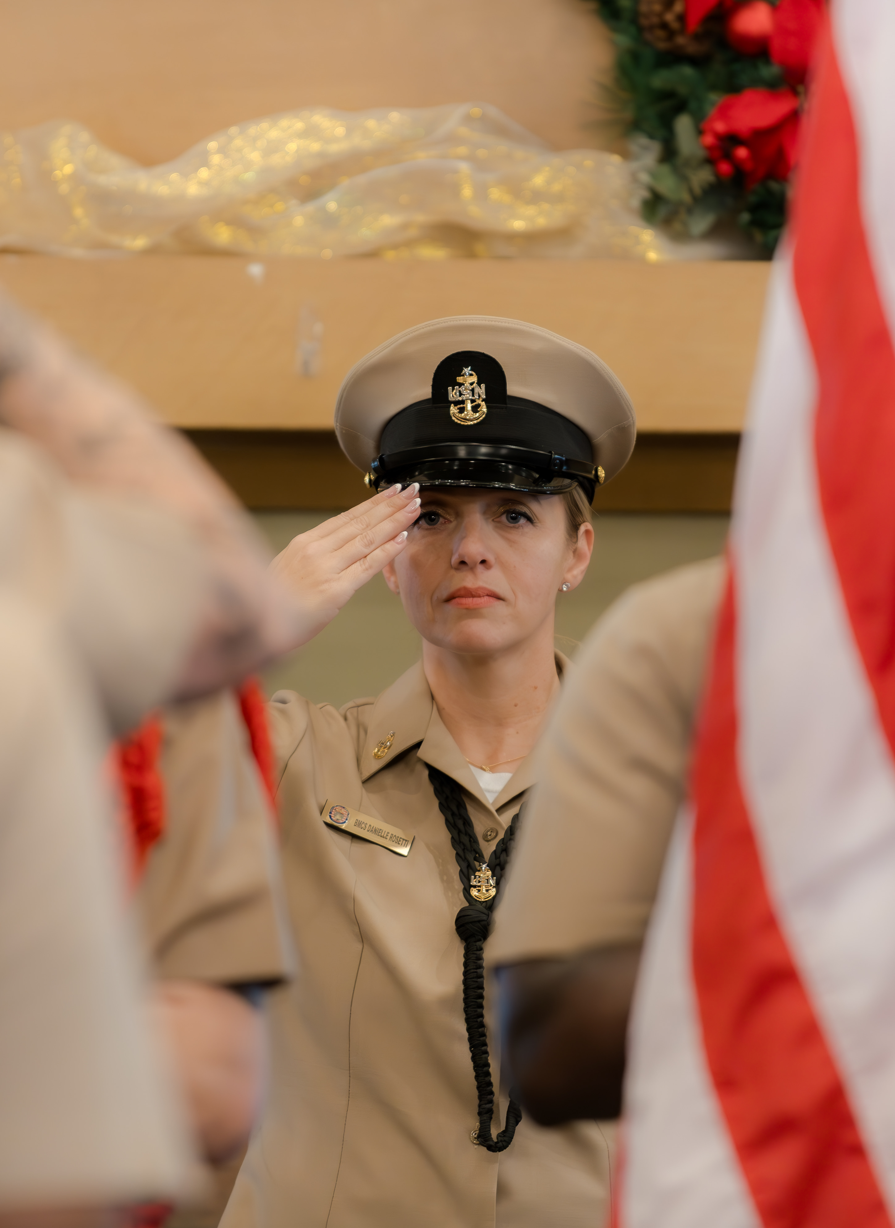Danielle Rosetti Lopez saluting at her U.S. Navy retirement ceremony